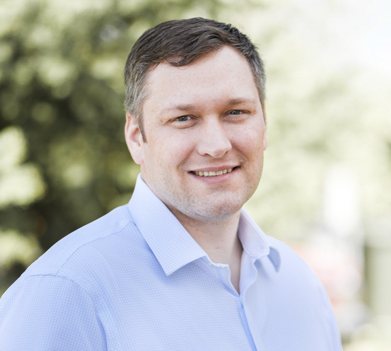 smiling outdoor portrait of Dr. Olson, white man with light brown hair